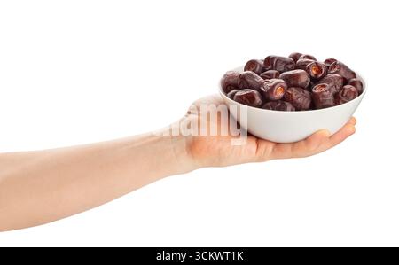 dattes fruits dans le chemin de la main isolé sur blanc Banque D'Images