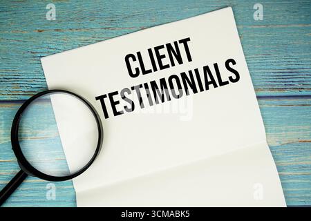 Témoignage client texte écrit sur bloc-notes avec loupe plate sur fond en bois Banque D'Images