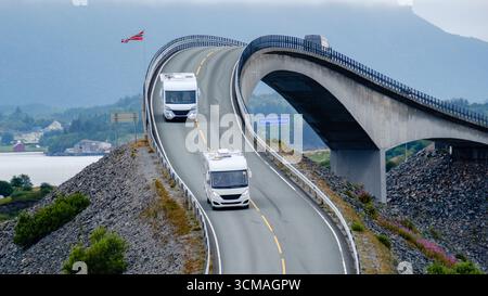 Découvrez la beauté époustouflante de l'Atlantic Ocean Road en Norvège, avec ses courbes sinueuses et ses vues imprenables sur l'océan. Deux camping-cars naviguent sur ce remarquable itinéraire côtier entouré par la nature. Banque D'Images