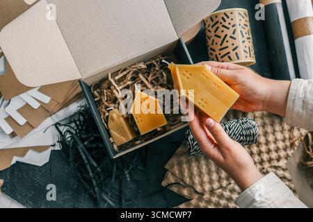 Bougie à la main dans les mains, concept d'emballage et de livraison de marchandises. Banque D'Images