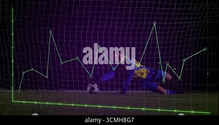 Sauver un gardien de but ciblé plongeant bas sur le terrain du stade la nuit, avec un graphique de données vert superposé Banque D'Images