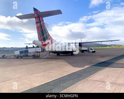 Îles Shetland aéroport piste avion atterrissage Lerwick queue route collines panneau routier Agneau mouton eau mer bruyère montagnes Aéroport Logan Air Banque D'Images
