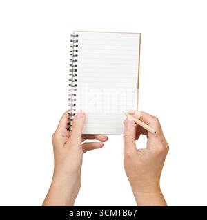 Mains tenant le crayon et l'écriture sur le cahier vide isolé sur fond blanc Banque D'Images