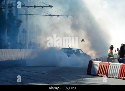 Sam Sam exécutant un impressionnant spectacle de dérive avec une BMW E30 325i à Budapest, produisant une fumée de pneu massive et divertissant la foule excitée Banque D'Images