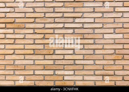 Brique propre dans des tons oranges chauds. Texture moderne, sophistiquée et vintage. Arrière-plan. Conception. Motif. Banque D'Images