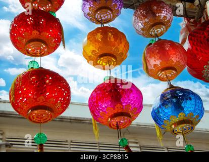 Regardant vers le haut des lanternes chinoises traditionnelles colorées suspendues contre un ciel bleu clair malacca malaisie Banque D'Images