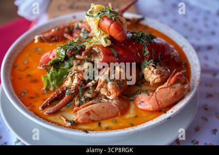 Un bol vapeur de Chupe de Camarones, la chaudrée de crevettes emblématique du Pérou, riche et réconfortante avec des crevettes fraîches de rivière, des pommes de terre, du lait et des épices andines Banque D'Images