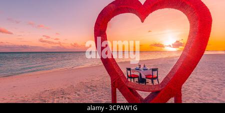 Table à dîner romantique décoration coeur rouge vue sur la mer, belle scène d'anniversaire de lune de miel, fond de destination de repas de vacances d'été de couple d'amour Banque D'Images