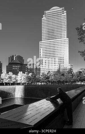 Homme nettoyant le marbre gravé du mémorial de 9-11, New York City, NY, États-Unis Banque D'Images
