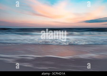 Long exposition paysage marin abstrait à la plage au coucher du soleil avec mouvement de l'eau de mer de l'océan et ciel coloré Banque D'Images