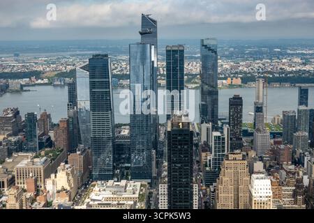 Vue sur les gratte-ciel imposants perce le ciel, reflétant la vaste rivière et le paysage urbain lointain dans leurs façades en verre, une merveille moderne, New York City, N. Banque D'Images