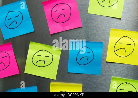 Allemagne - 27 septembre 2025 : de nombreux visages tristes sur des Post-it colorés. *** Vue traurige Gesichter auf bunten Post-its. Banque D'Images