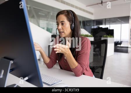Femme engagée dans la réunion en ligne ou la tâche de soutien à la clientèle Banque D'Images
