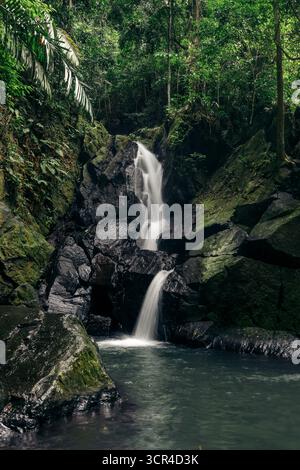 Cascade de Pria Laot en cascade sur des rochers moussseux dans un cadre de forêt verdoyante. We Island, Aceh, Sumatra, Indonésie Banque D'Images