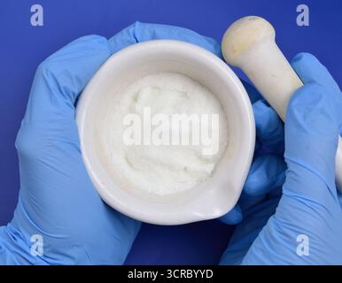 Poudre de métronidazole sur fond bleu Banque D'Images