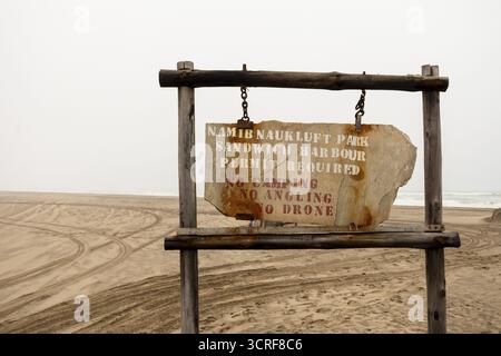 Panneau routier affichant le nom du parc national Namib-Naukluft contre un paysage désertique sous un ciel nuageux, Namibie - 30 août 2025 Banque D'Images