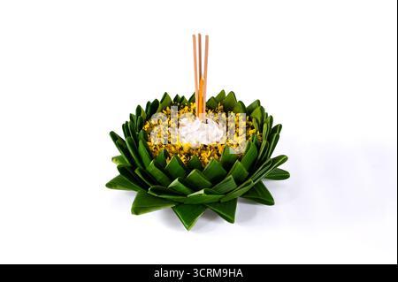 Feuille de banane Krathong qui ont 3 bâtons d'encens et la bougie décorent avec des fleurs blanches et jaunes pour la pleine lune de Thaïlande ou Loy Krathong festival iso Banque D'Images