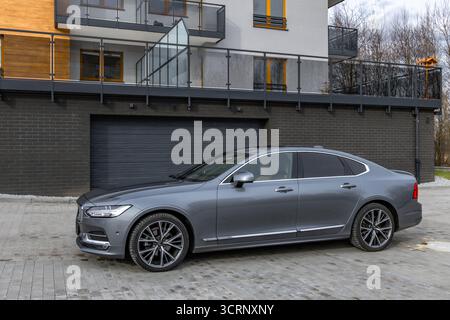 Une limousine de luxe grise et bleue à quatre portes garée dans le parking devant l'entrée du garage. En Pologne Banque D'Images