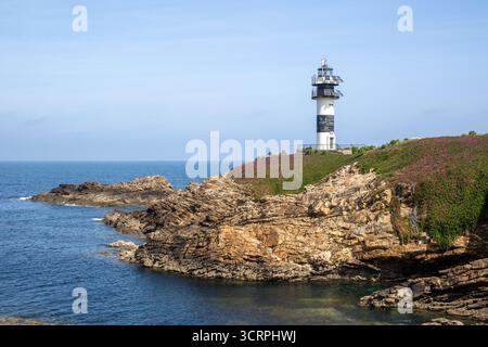 Phare d'Isla Pancha entouré de falaises accidentées et d'eaux de l'Atlantique près de Ribadeo, dans la région côtière de Galice dans le nord de l'Espagne. Banque D'Images