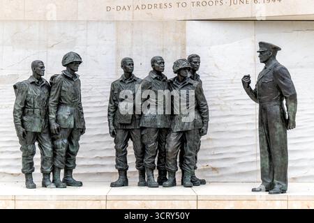 Monument commémoratif Dwight d Eisenhower Statue de bronze Washington DC // WASHINGTON DC — le monument commémoratif Dwight d Eisenhower présente une statue en bronze du général Dwight D. Eisenhower, commandant suprême du corps expéditionnaire allié, s'adressant aux troupes américaines. Cette scène commémore son discours du jour J aux troupes le 6 juin 1944, avant le débarquement de Normandie pendant la IIe Guerre mondiale. Le mémorial, dédié en 2020, honore le leadership d'Eisenhower en tant que commandant militaire et 34e président des États-Unis. Les statues de bronze représentent Eisenhower et les soldats dans leurs uniformes de guerre sur fond de sculptures en relief Banque D'Images