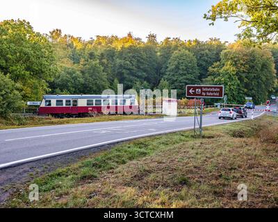Gernrode, Deutschland 29.09.2025, Im Bild : Triebwagen 187 016-1 der Harzer Schmalspurbahnen HSB durchfährt Am 29. Septembre 2025 den Haltepunkt Sternhaus-Haferfeld. IM Licht des frühen Herbstmorgens trifft nostalgische Eisenbahnromantik auf modernen Straßenverkehr ein Sinnbild für die Bedrohte, aber weiterhin lebendige Selketalbahn im Harz. Saxe-Anhalt *** Gernrode, Allemagne 29 09 2025 dans l'image, wagon 187 016 1 des chemins de fer à voie étroite du Harz HSB passe par l'arrêt Sternhaus Haferfeld le 29 septembre 2025 à la lumière du début de l'automne matin, nostalgique romance ferroviaire m Banque D'Images