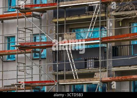 Échafaudage en aluminium installé sur la façade d'un immeuble de grande hauteur, murs isolés au polystyrène, rénovation d'un immeuble Banque D'Images