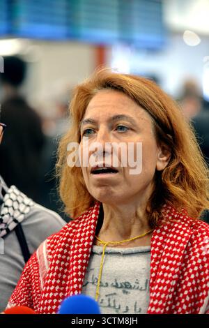 Orly, France. 07 octobre 2025. Lyna Altabal, professeure de droit international, membre du GSF et activistes qui naviguaient à bord de navires de la flottille humanitaire à destination de Gaza avant d’être arrêtés et détenus par les forces israéliennes, éclairent le signe de paix alors qu’ils sont accueillis par une foule de partisans dans la zone des arrivées de l’aéroport d’Orly, dans la banlieue de Paris, en France, le 7 octobre 2025. Photo de Karim ait Adjedjou/ABACAPRESS.COM crédit : Abaca Press/Alamy Live News Banque D'Images
