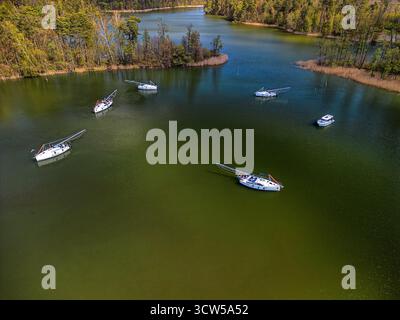 Plan aérien de voiliers dispersés sur le lac Guzianka en été, vue en angle élevé par drone capturant une scène de navigation sereine Banque D'Images
