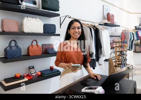 Heureuse jeune femme chef de magasin de mode indienne posant pour le portrait Banque D'Images
