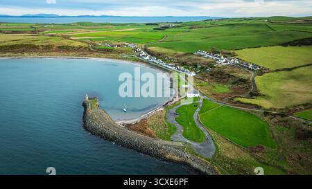 Vue aérienne du village et du port de Port Logan, Dumfries et Galloway, Écosse, montrant le village côtier et la baie. Banque D'Images