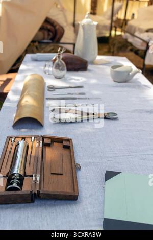 Instruments chirurgicaux anciens disposés sur un tissu de lin dans un cadre médical historique, représentant des soins de santé à l'ancienne et les outils du ph passé Banque D'Images