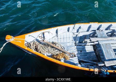 Un vieux bateau en bois sur l'eau, dans lequel se trouve une corde avec un crochet en acier, vue de dessus Banque D'Images