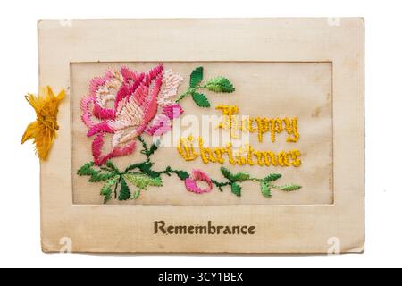 WW ! Carte de voeux de Noël brodée en soie. Joyeux Noël avec rose rouge. Banque D'Images