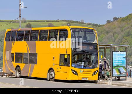 Dartmouth, Devon, Angleterre, Royaume-Uni - 24 avril 2025 : les gens prennent un bus à impériale exploité par Stagecoach à un arrêt de bus dans la ville de Dartmouth. Banque D'Images