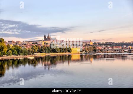 Vue matinale sur la rivière Vltava vers les tours historiques et les bâtiments de la vieille ville de Prague, République tchèque, avec des reflets dans l'eau calme. Banque D'Images