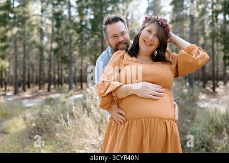 Couple dans une forêt pour un shooting de maternité Banque D'Images
