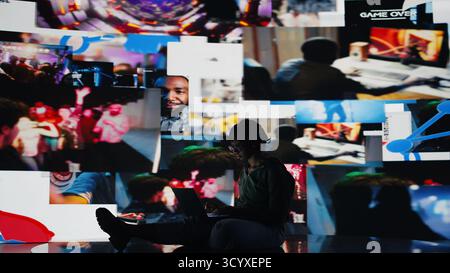 Jeune femme naviguant sur Internet à l'aide d'un ordinateur portable, regardant du contenu sur les services de streaming vidéo. Adolescent afro-américain regardant des émissions de VOD divertissantes en ligne à l'aide d'un ordinateur portable, caméra A. Banque D'Images