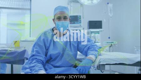 Chirurgien masculin assis seul reposant sur la table d'opération à l'hôpital OU, avec moniteur patient Banque D'Images