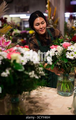 Femme fleur vendeur prépare un bouquet de luxe Banque D'Images