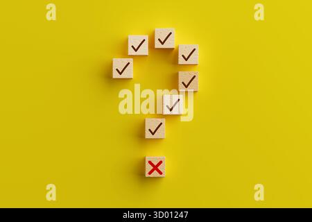 Prise de décision et concept d'incertitude. Cubes en bois formant point d'interrogation avec des marques de contrôle et Croix-Rouge sur fond jaune. Rendu 3D. Banque D'Images