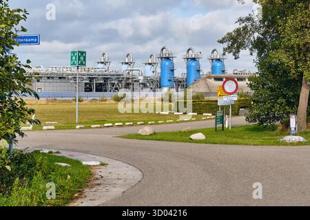 Langelo, pays-Bas ; 10 octobre 2025 : route d'entrée du site de stockage de gaz Nam avec tours d'absorption bleues, signalisation de sécurité et structures industrielles un Banque D'Images