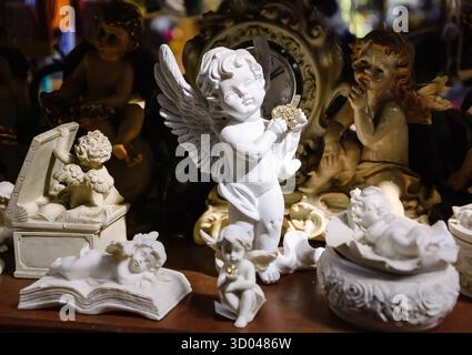 Anges en plâtre blanc à vendre au marché aux fleurs à Paris. Fond vintage. Mise au point sélective. Banque D'Images