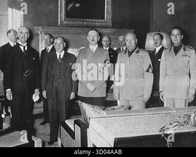 MUNICH, ALLEMAGNE - 29 septembre 1938 - les principaux protagonistes du tristement célèbre accord de Munich de 1938, signé à Munich le 29 septembre 1938 entre le premier ministre britannique Neville Chamberlain, le premier ministre français Edouard Daladier, le président italien Benito Mussolini et Adolf Hitler, autorisent l'Allemagne fasciste à annexer la Tchécoslovaquie. De gauche à droite : Chamberlain, Daladier, Hitler, Mussolini et le ministre italien des Affaires étrangères, le comte Galeazzo Ciano. En arrière-plan, de gauche à droite, se trouvent une personne inconnue (probablement un diplomate britannique), Fromageot, Ribbentrop, Weizsäcker et léger, alias Saint-J. Banque D'Images
