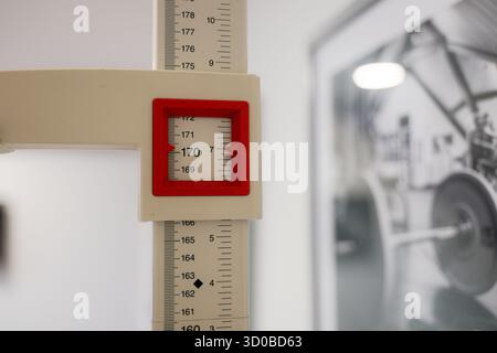 Une règle avec un carré rouge est placée sur un mur blanc. La règle est marquée avec des numéros de 150 à 190 Banque D'Images