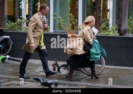 Les Londoniens négocient des vents forts de la tempête Benjamin dans la ville de Londres, le quartier financier de la capitale, le 23 octobre 2025, à Londres, en Angleterre. Benjamin a causé des pannes de courant dans l'est de l'Angleterre après que le met Office a émis un avertissement météorologique, estimant la vitesse du vent jusqu'à 70 mph (113 km/h). Banque D'Images