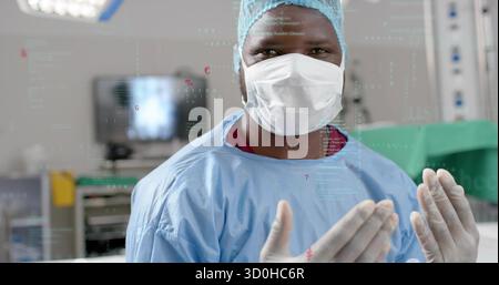 Chirurgien adulte portant une blouse stérile et se préparant en salle d'opération, avec moniteur chirurgical Banque D'Images