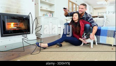 Couple tenant à distance appuyé sur le tapis dans le salon, avec bouledogue français par cheminée, espace copie Banque D'Images