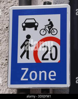 23.10.2025, Handenberg, AUT, Unterwegs in Oberösterreich, Themenbild, Symbolbild, Verschiedene Themenbilder, Verkehrszeichen, im Bild Das Bild zeigt ein Verkehrsschild in einer blauen und weißen Farbgestaltung. Es enthält folgende symbole Ein Auto, Ein Fahrradfahrer, Eine gehende person, Unter diesen Symbolen befindet sich ein roter Kreis mit der Zahl 20 , was auf eine Geschwindigkeitsbegrenzung von 20 km/h hinweist. AM unteren Rand des Schildes steht das Wort zone .Das Schild dient dazu, die Geschwindigkeit in einem bestimmten Bereich zu regulieren und auf die Anwesenheit von Fußgängern und R Banque D'Images