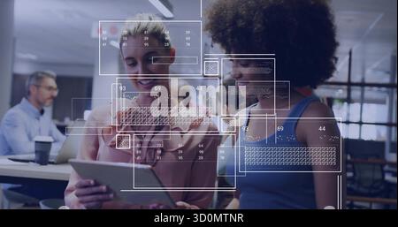 Deux collègues femmes examinant le code sur tablette dans un bureau ouvert, avec superposition graphique de l'interface utilisateur Banque D'Images