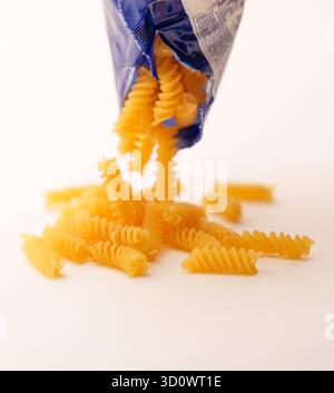 Pâtes de blé dur : Rotini Spirals tombant sur un fond propre Banque D'Images